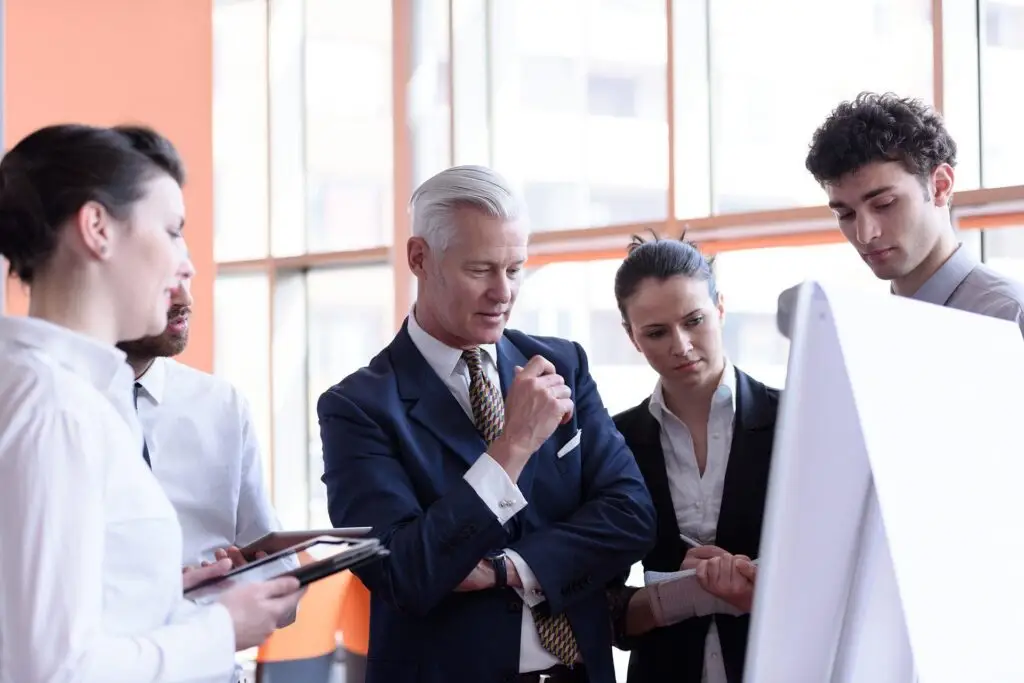 diverse team collaborating in modern office, fostering innovation and communication.
