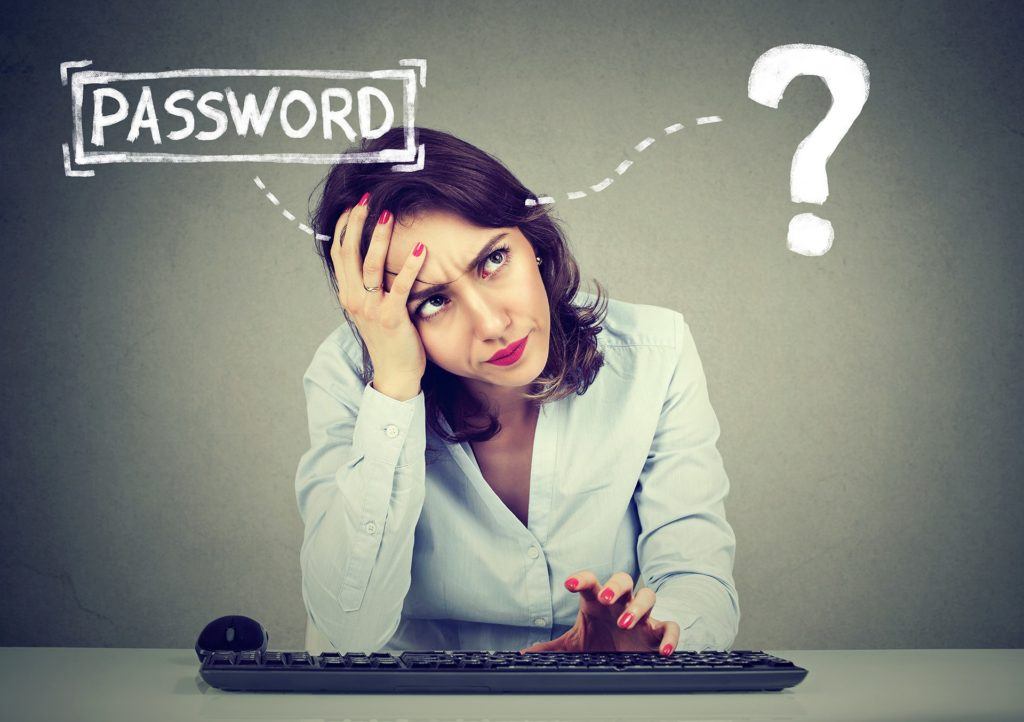 tech frustration: woman puzzled by forgotten password at computer. remember unique passwords.