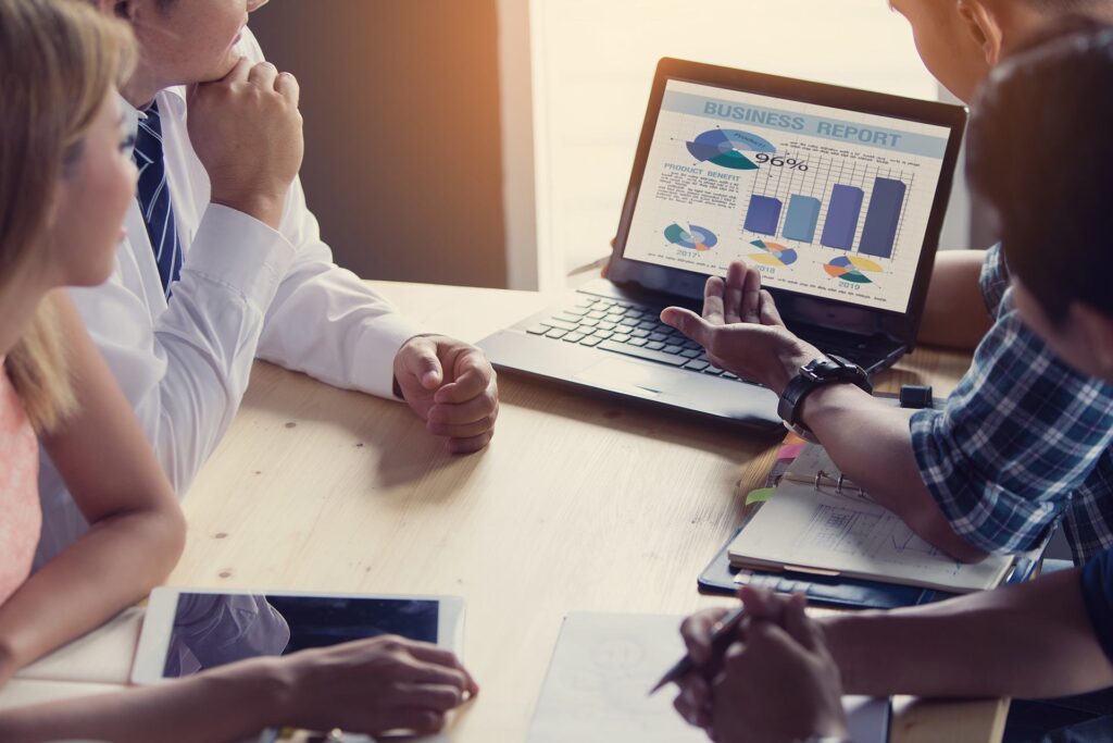 diverse team analyzing data trends in modern office meeting. business intelligence.