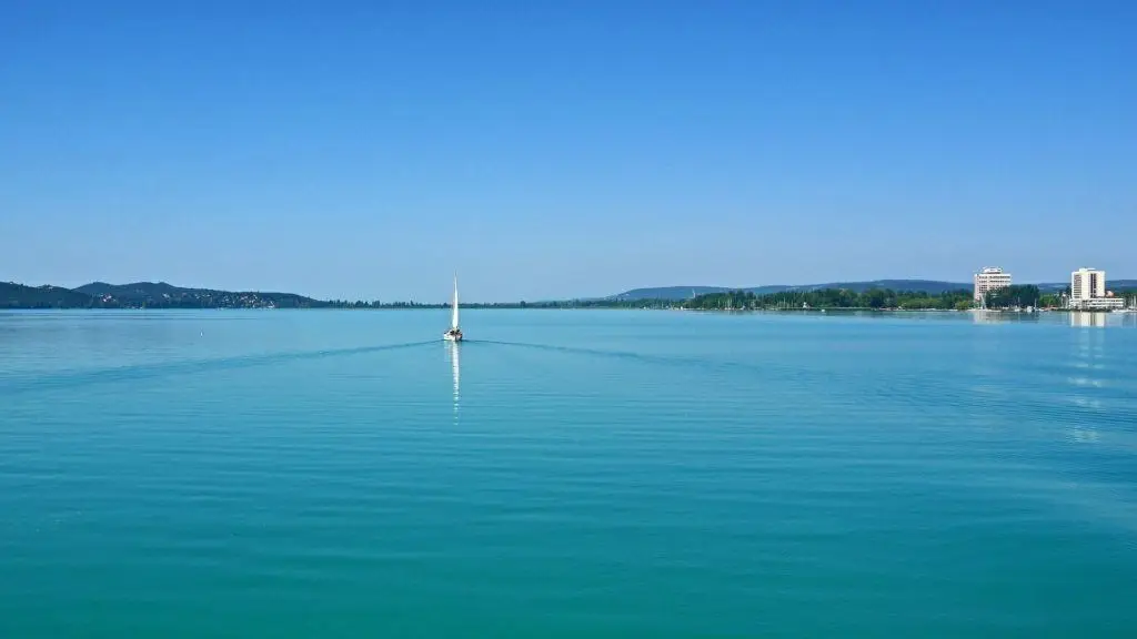 Tranquil Sailboat Glides On Serene Blue Lake, Creating Peaceful Escape. Business Continuity Plan. tranquil sailboat glides on serene blue lake, creating peaceful escape. business continuity plan.