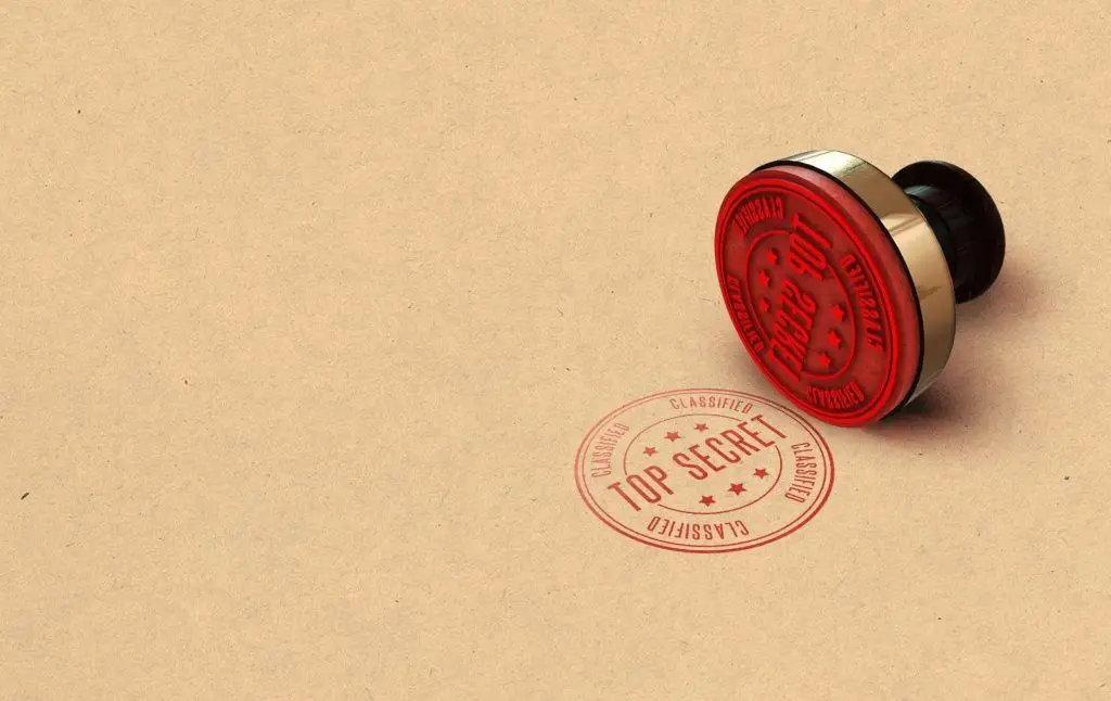 classic top secret red stamp on kraft paper background for confidentiality and authority. watermark.