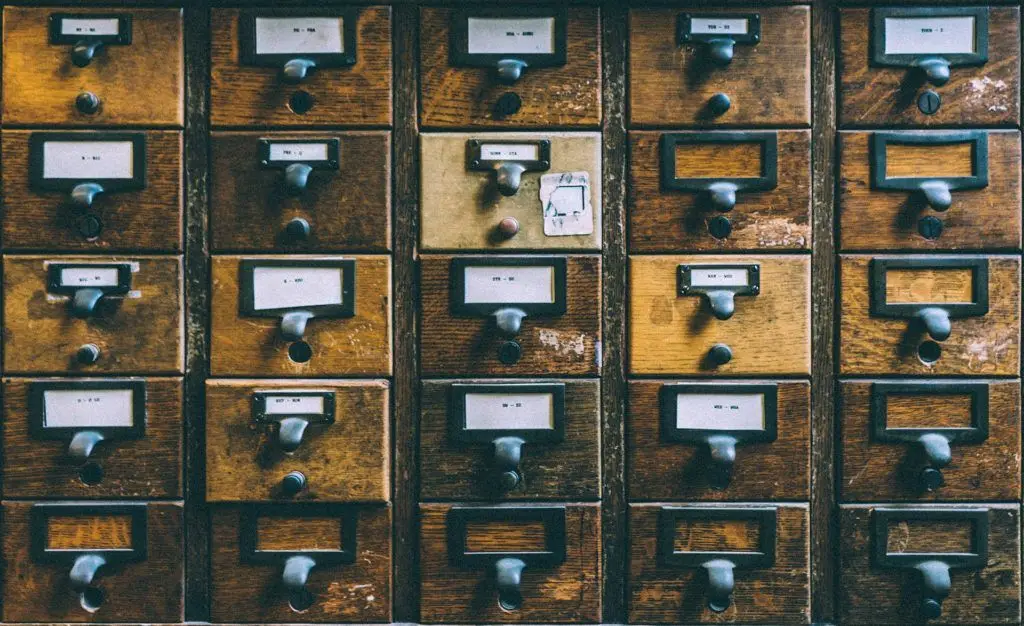 vintage wooden filing cabinet exuding organized nostalgia and charm in a grid pattern. file. files organized