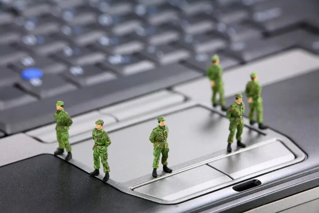 Toy Soldiers Strategically Placed On Laptop Keyboard, Blending Technology And Military Play. Small Business Backup. Data Breaches. toy soldiers strategically placed on laptop keyboard, blending technology and military play. small business backup. data breaches.