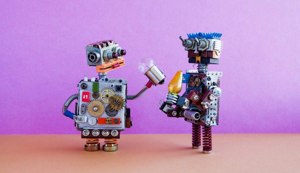 whimsical robots sharing a playful moment against vibrant purple backdrop, exuding camaraderie and fun. artificial intelligence.