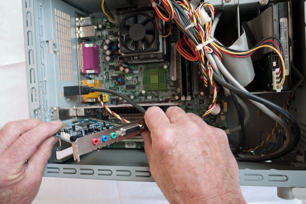 hands-on computer assembly with precise circuit board installation. troubleshooting.