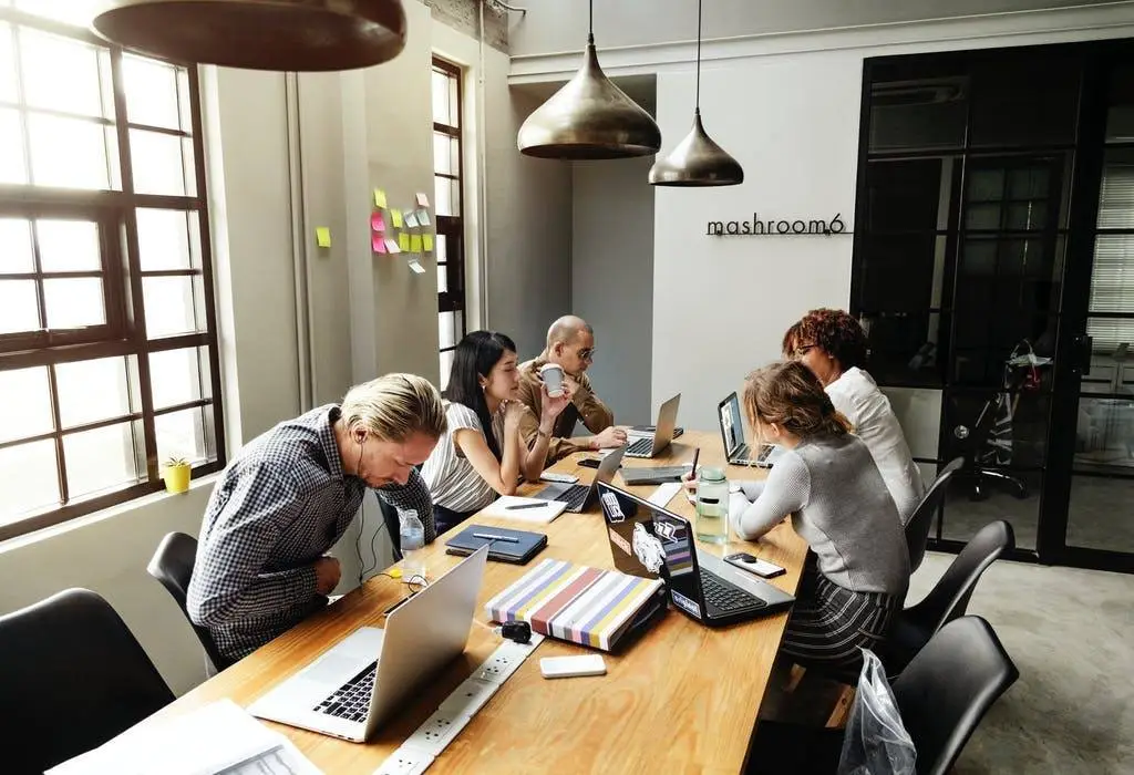 Collaborative Team Meeting In Modern Office With Natural Light And Minimalist Decor. Microsoft. collaborative team meeting in modern office with natural light and minimalist decor. microsoft.