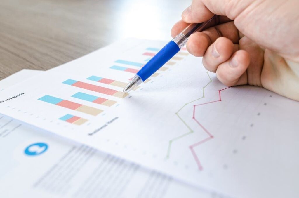colorful data graphs analyzed with a pen for decision-making in a focused workspace. tumblr.