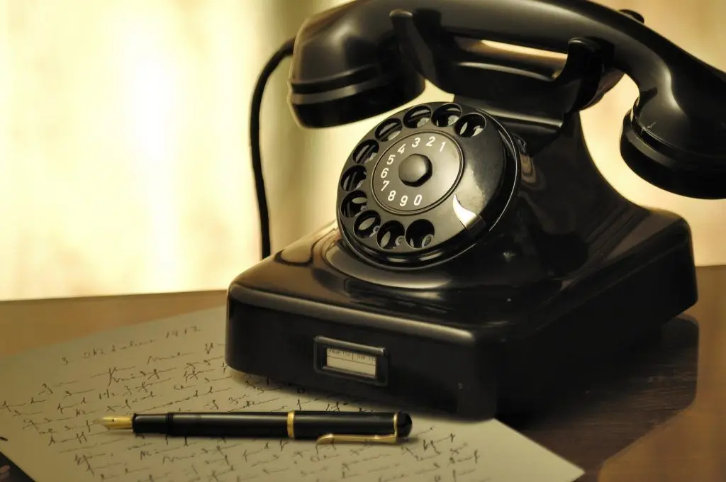 Vintage Telephone And Pen Evoke Nostalgia And Intimate Communication In Serene Setting. vintage telephone and pen evoke nostalgia and intimate communication in serene setting.