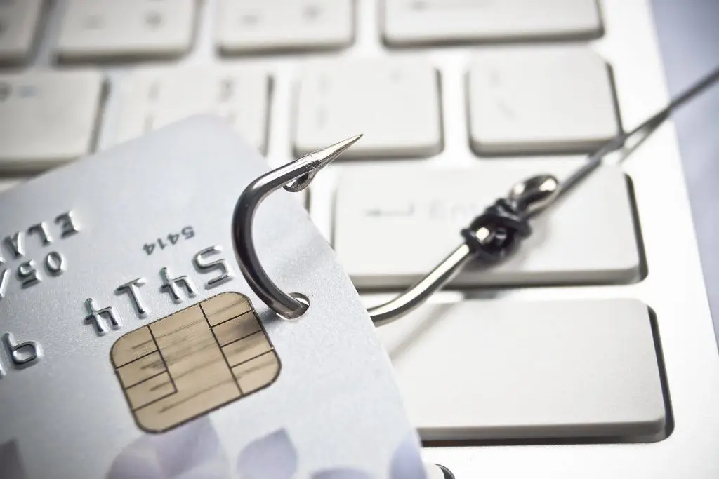 Be Cautious: Credit Card Phishing Threat Highlighted With Hook On Keyboard. be cautious: credit card phishing threat highlighted with hook on keyboard.