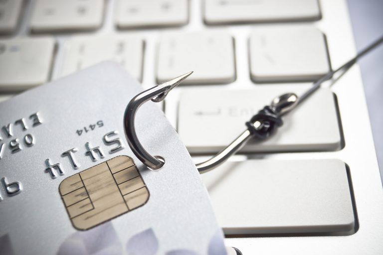 be cautious: credit card phishing threat highlighted with hook on keyboard.