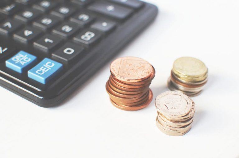 managing finances with calculator and coins for effective budgeting and planning.