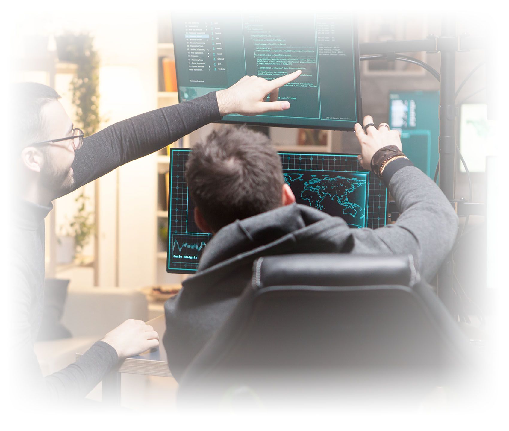 Back view of hackers pointing on computer screens. Dangerous terrorists. Managed Security