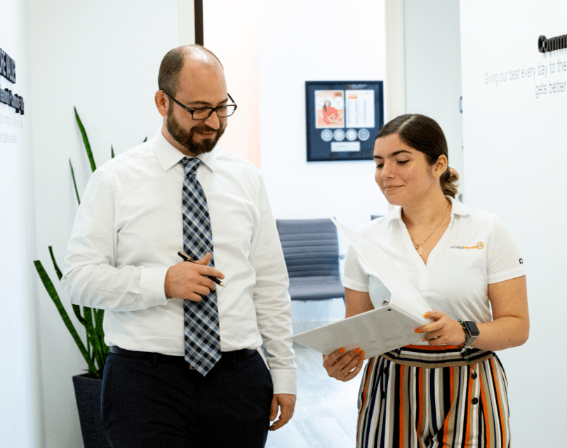 a man and woman are standing in an office