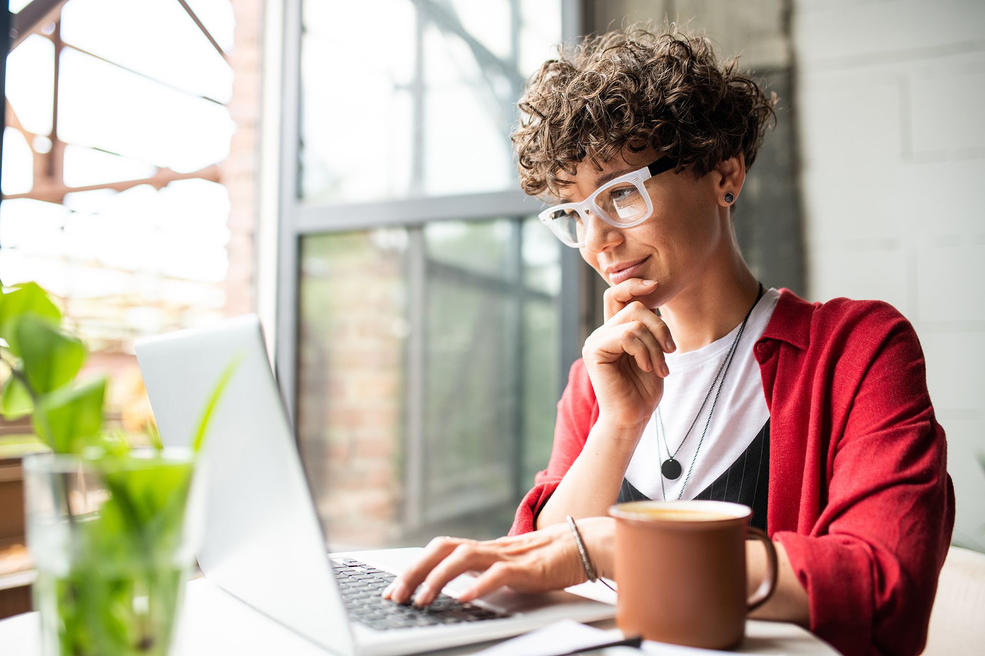 a person sitting at a table with a laptop