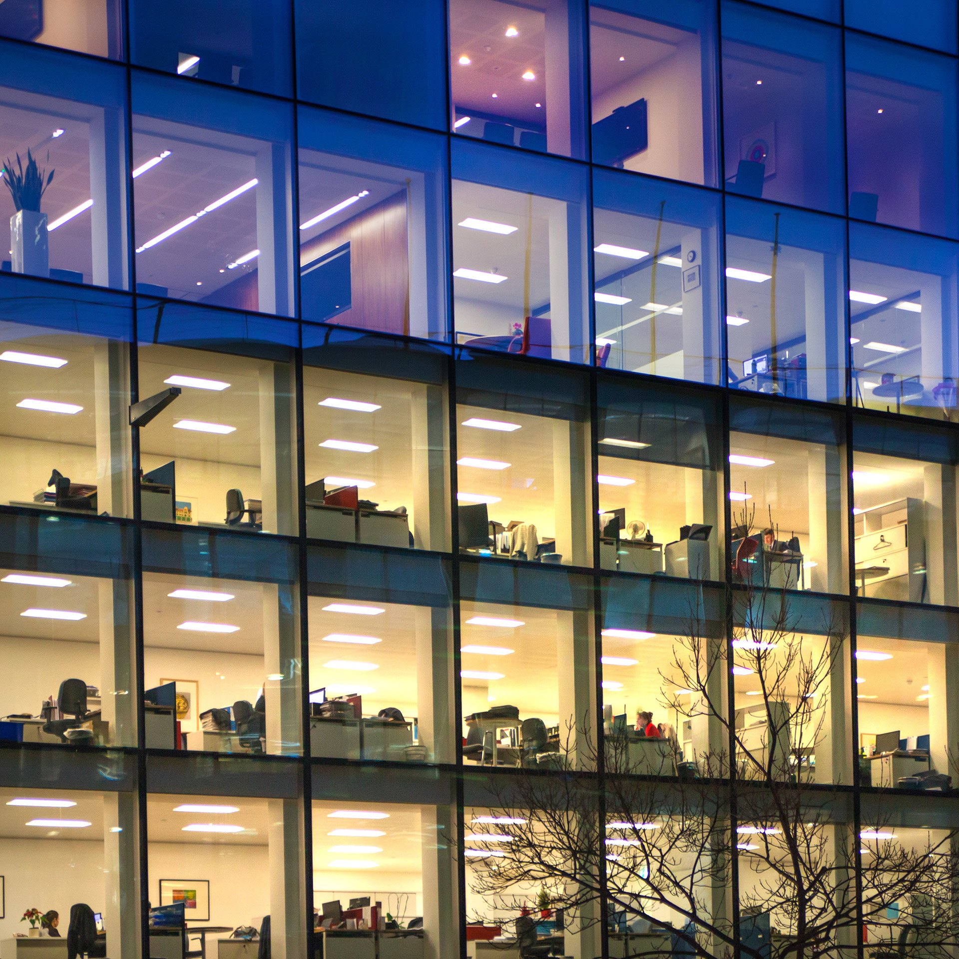 an office building is lit up at night