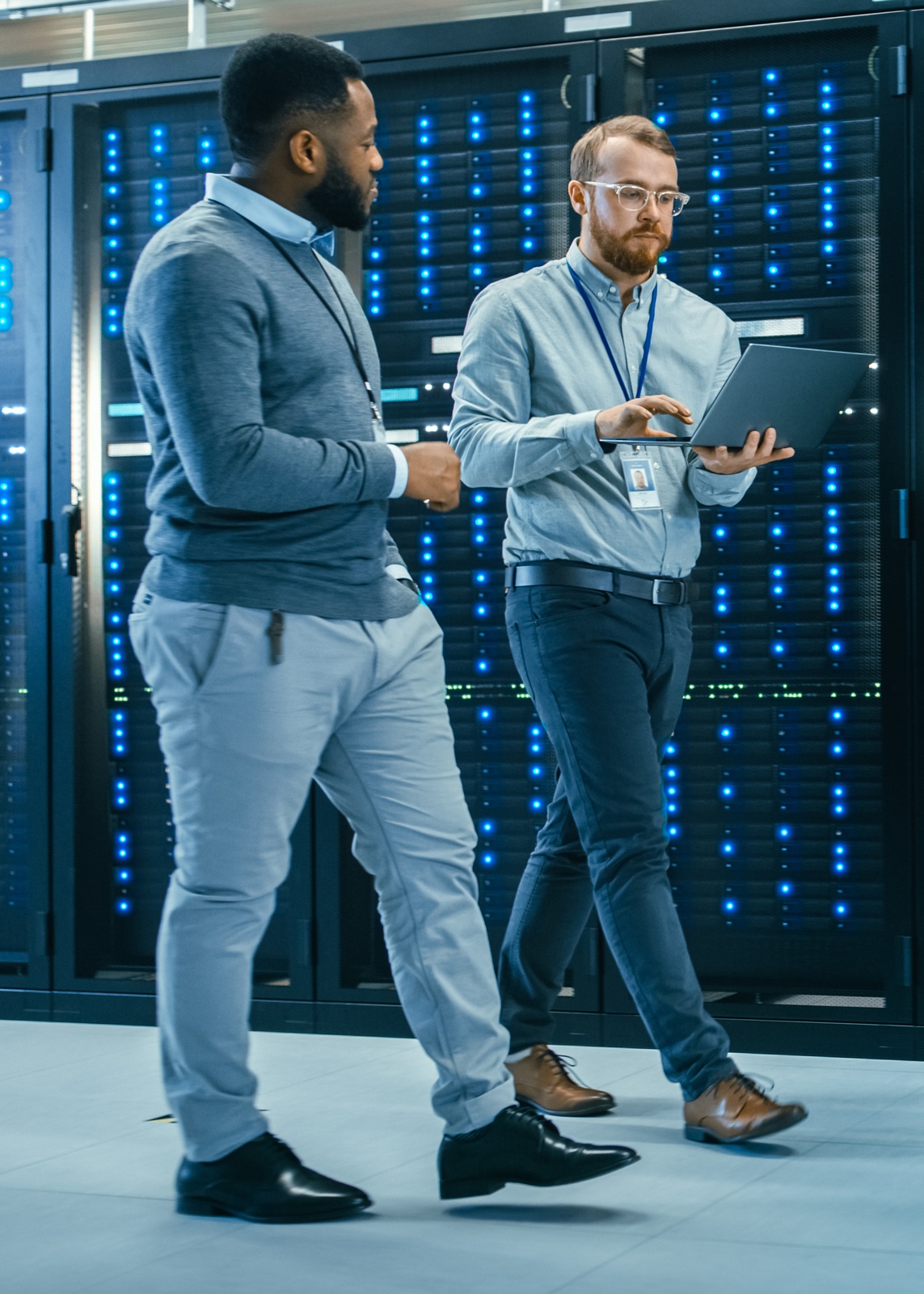 two men standing in front of a server