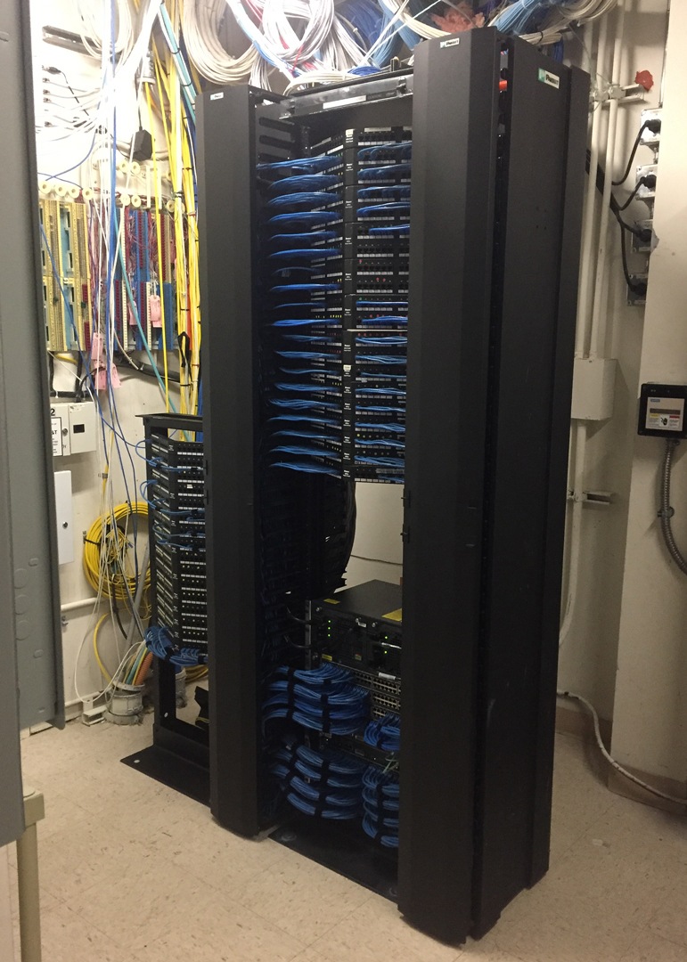 two large black racks with blue and yellow wires