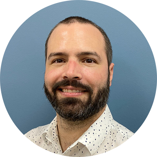 a man with a beard wearing a shirt and tie