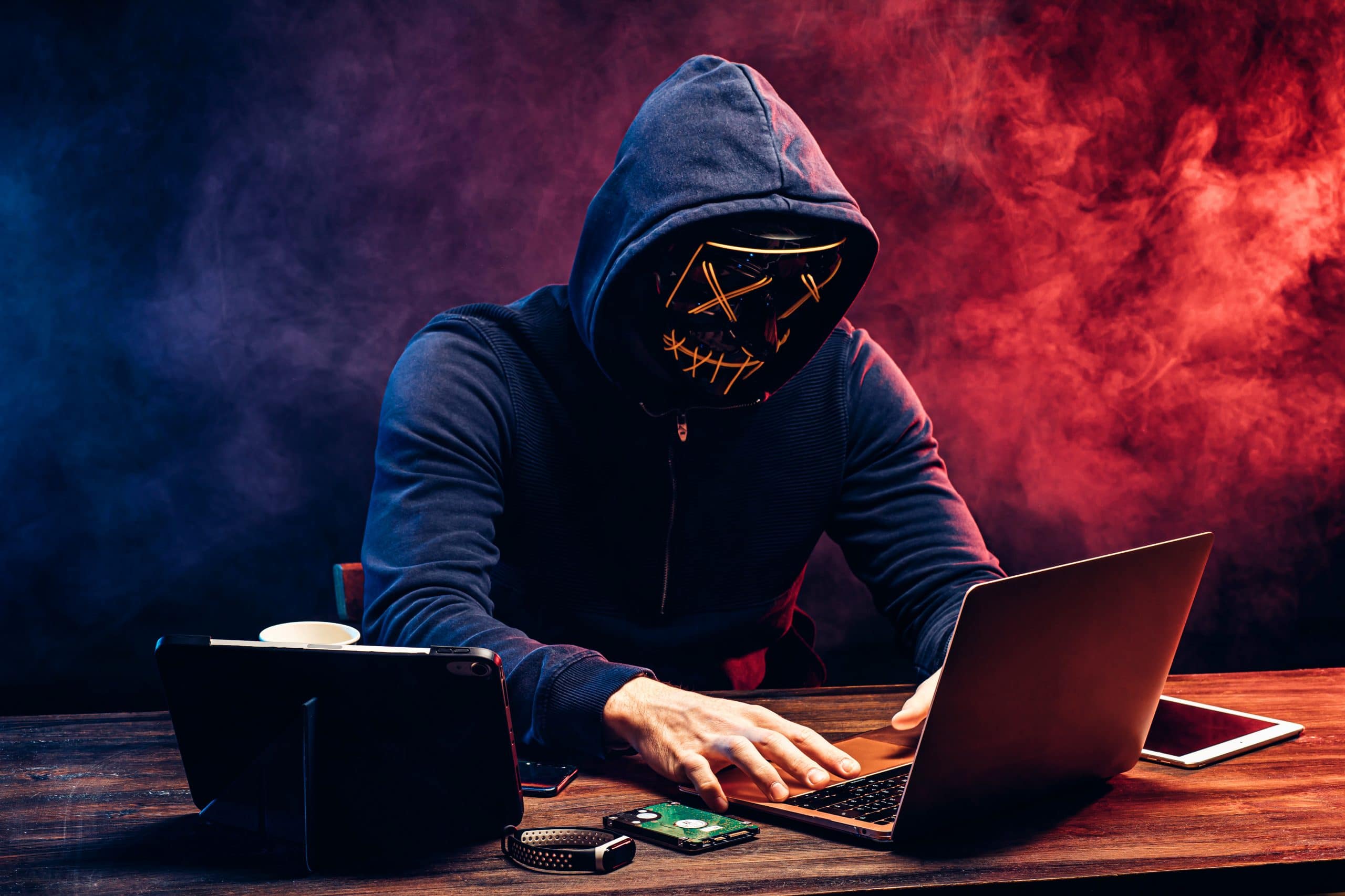 a person in a mask using a laptop