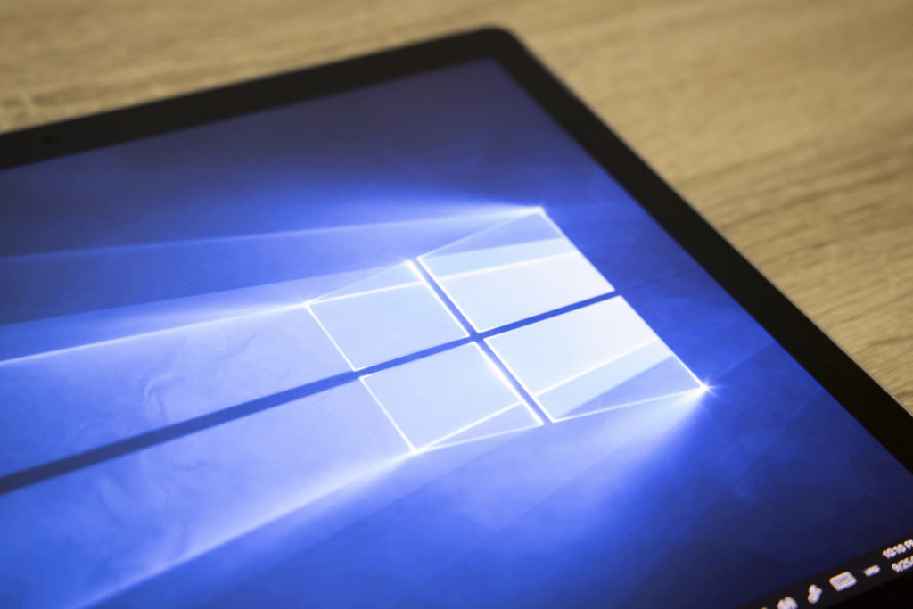 luminous windows 10 boot-up screen with iconic logo and taskbar for modern devices.