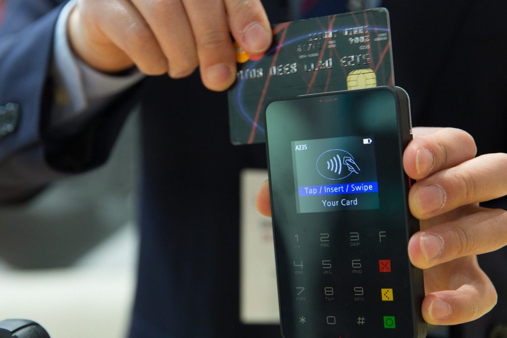 secure contactless payment with credit card in modern business transaction.