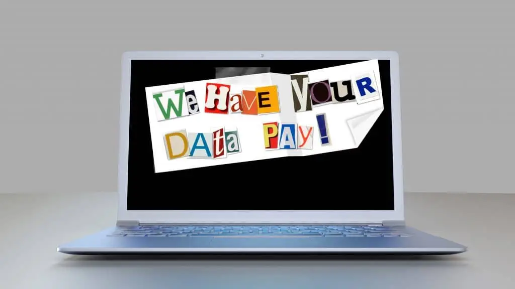 beware: ransomware warning on modern laptop screen with colorful cut-out letters.
