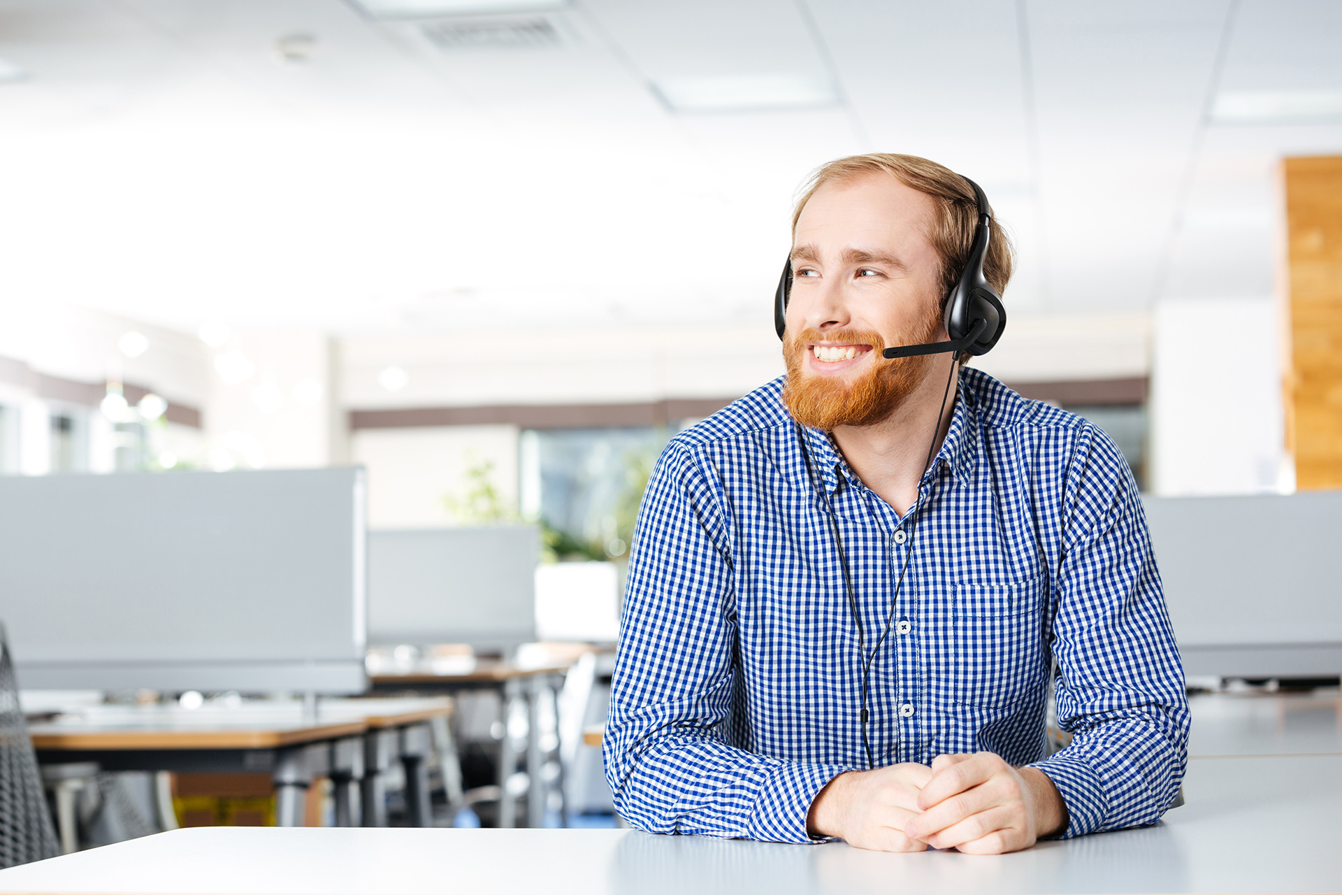 friendly modern office professional delivering excellent customer service with a smile.