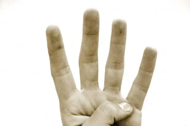 Hand Displaying Four Fingers In Symbolic Gesture Against Bright White Background. Remember hand displaying four fingers in symbolic gesture against bright white background. remember