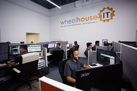 a group of people working on computers in an office