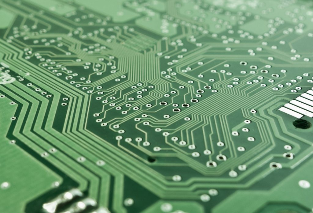 precision and complexity in modern pcb design - intricate green circuit board close-up.