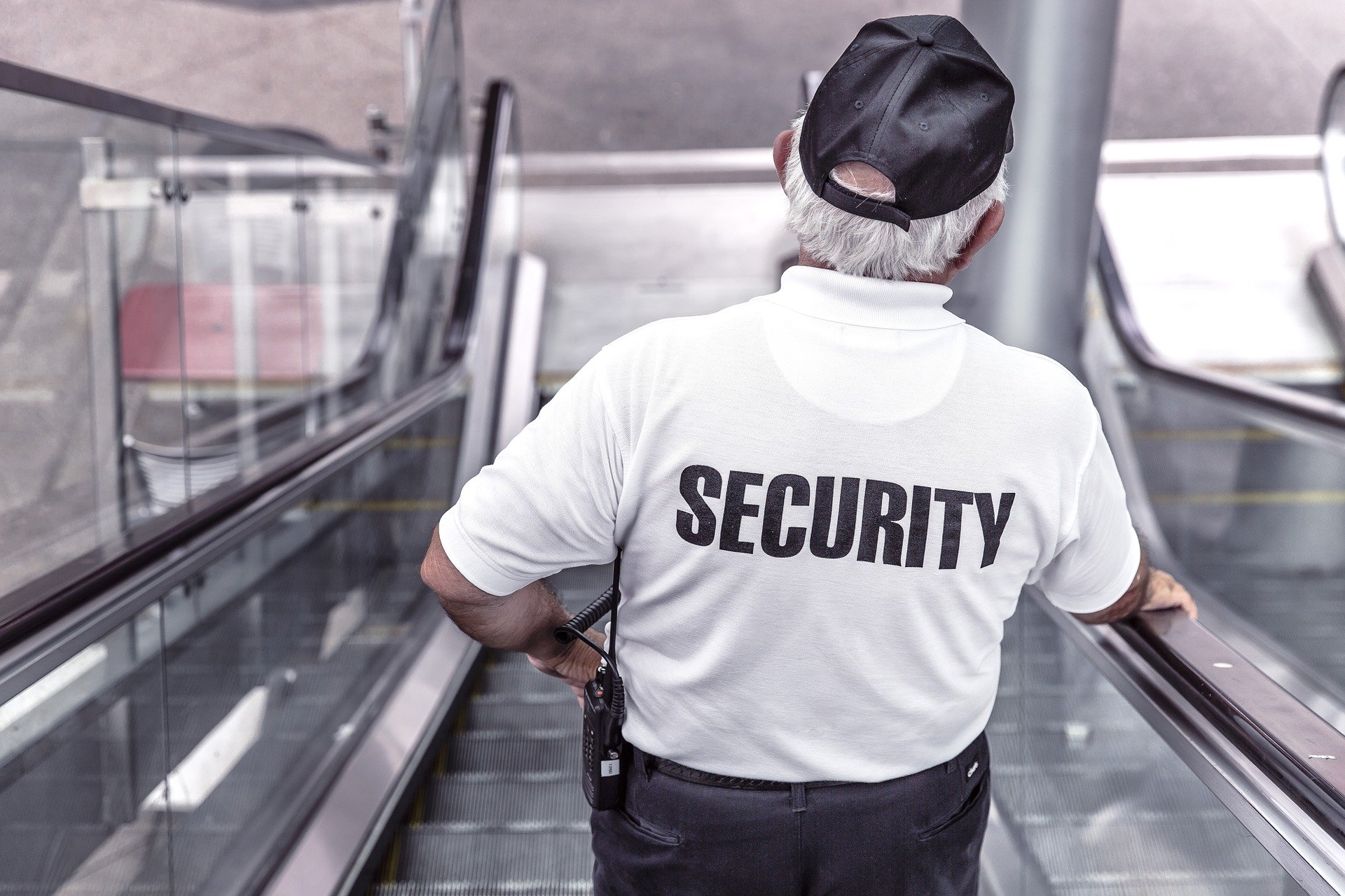 a security man is riding an escalator down the escalator