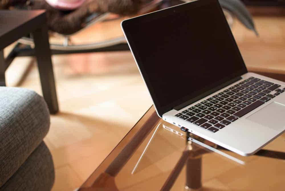 an open laptop computer sitting on top of a glass table