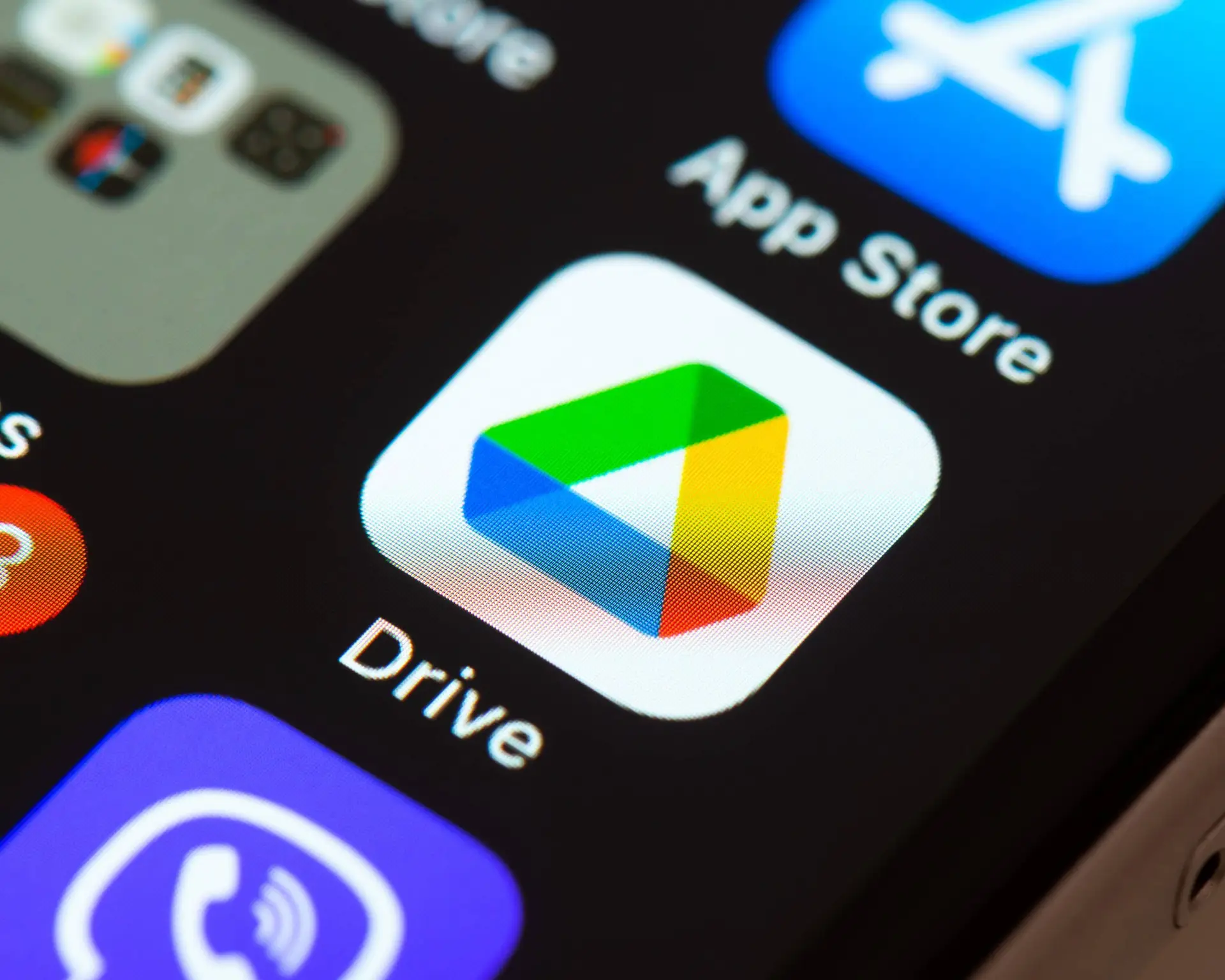 Modern smartphone screen with Google Drive and App Store icons for digital file management.