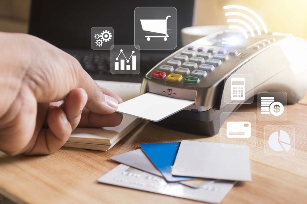 a person holding a credit card near a phone