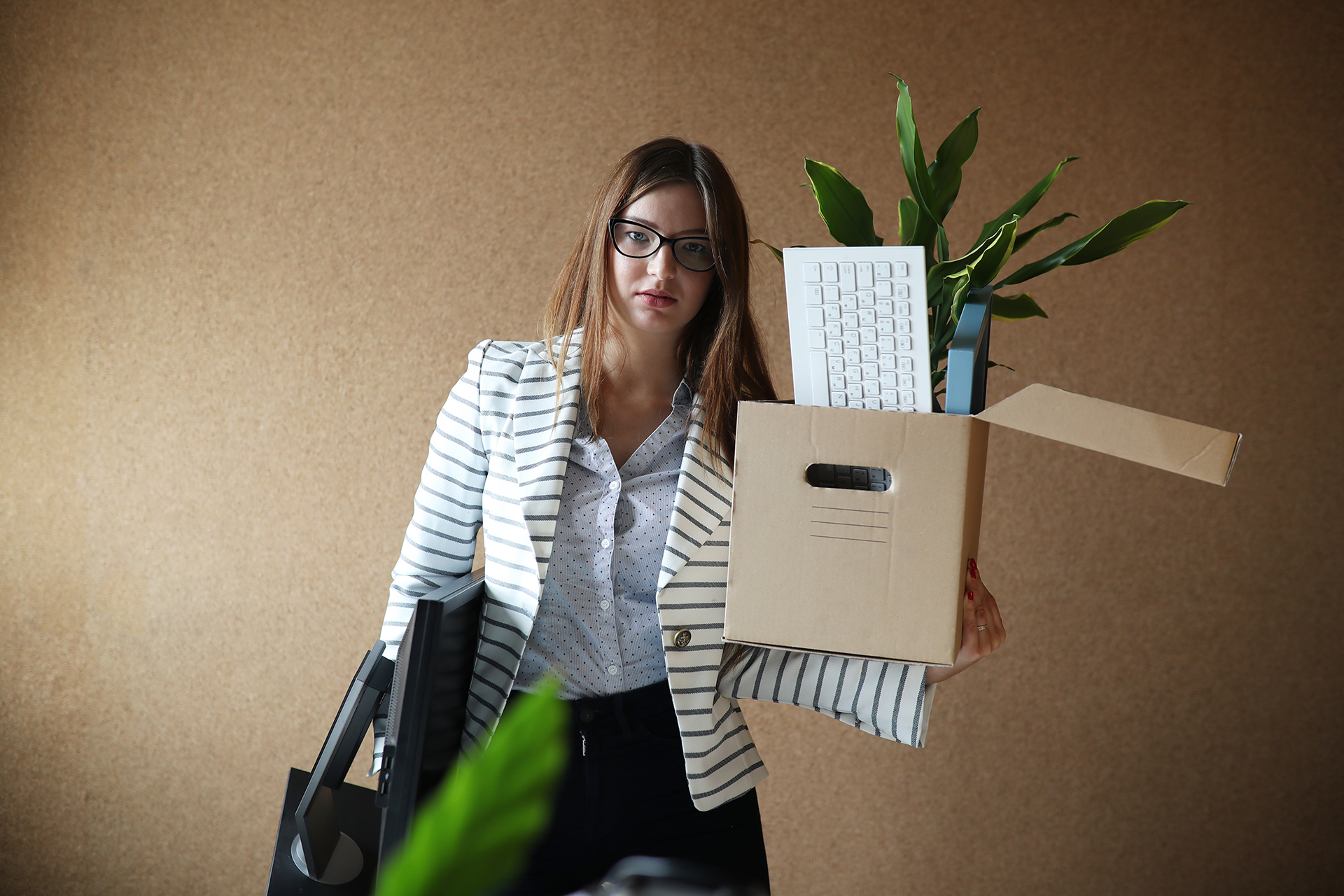 a woman holding a cardboard box and a keyboard
