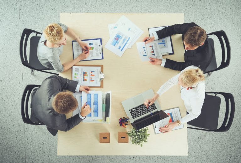 collaborative professionals discussing data analysis and strategy in modern meeting.