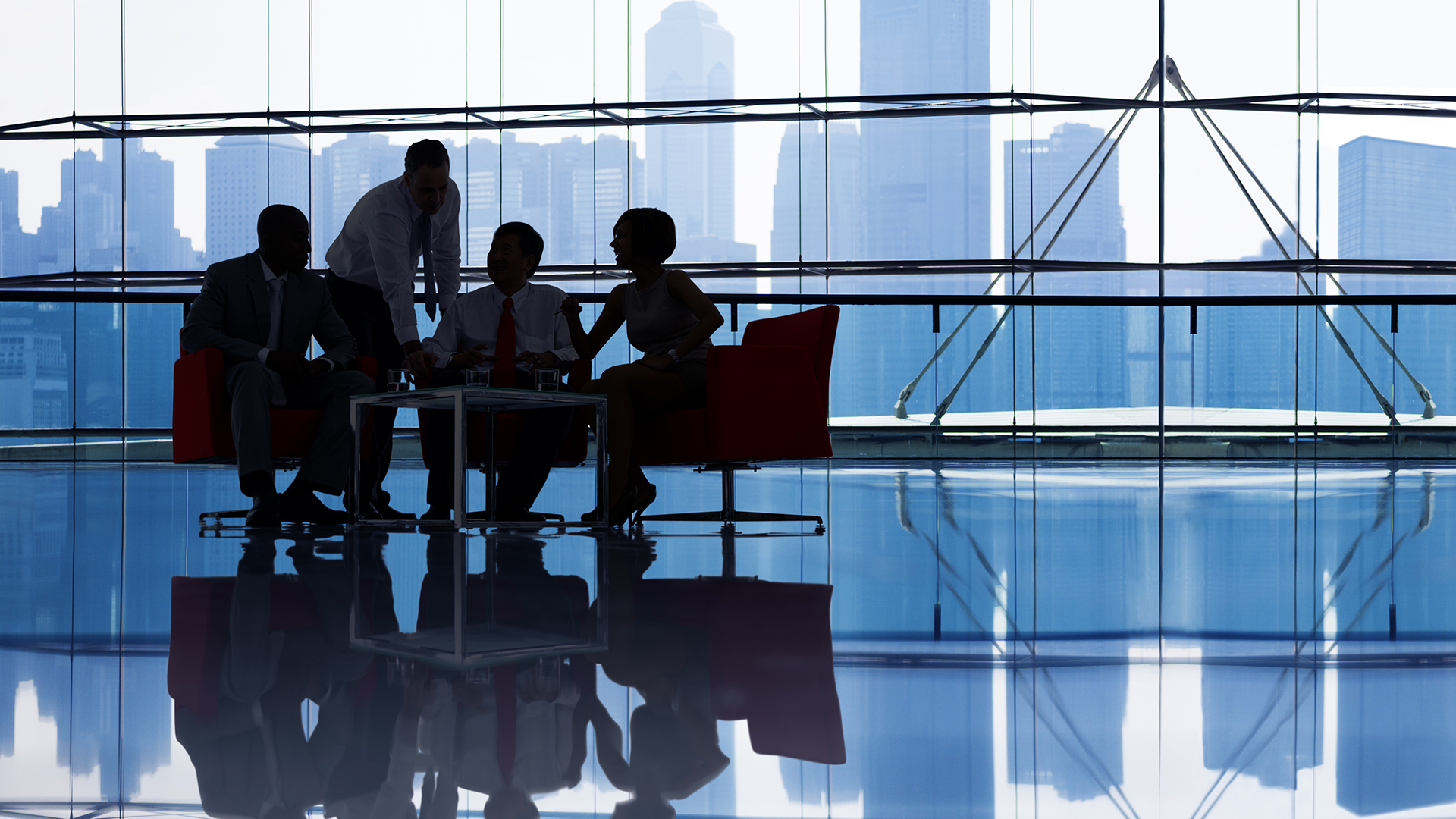 a group of people sitting around a table in front of a window