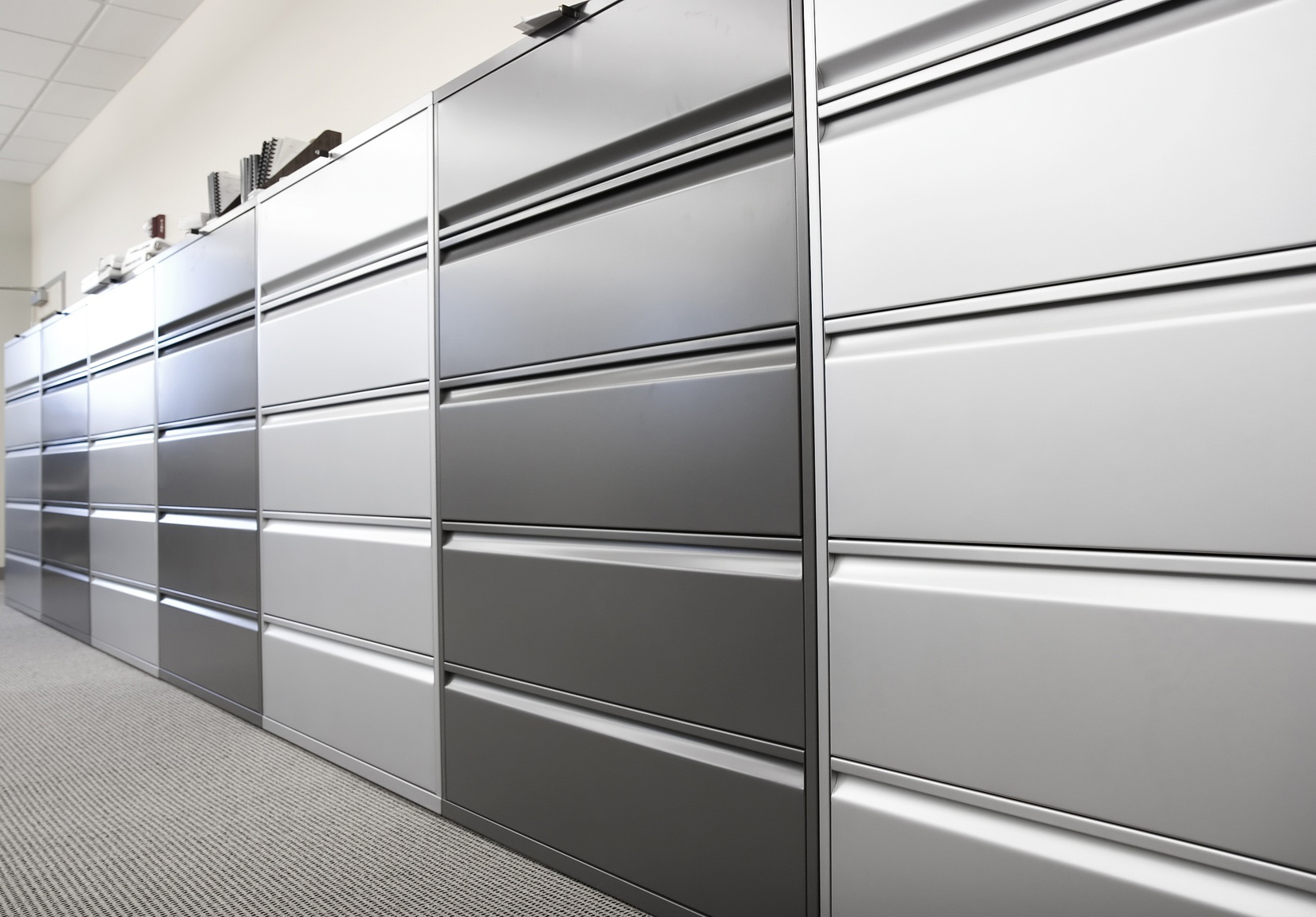 a row of metal filing cabinets in an office