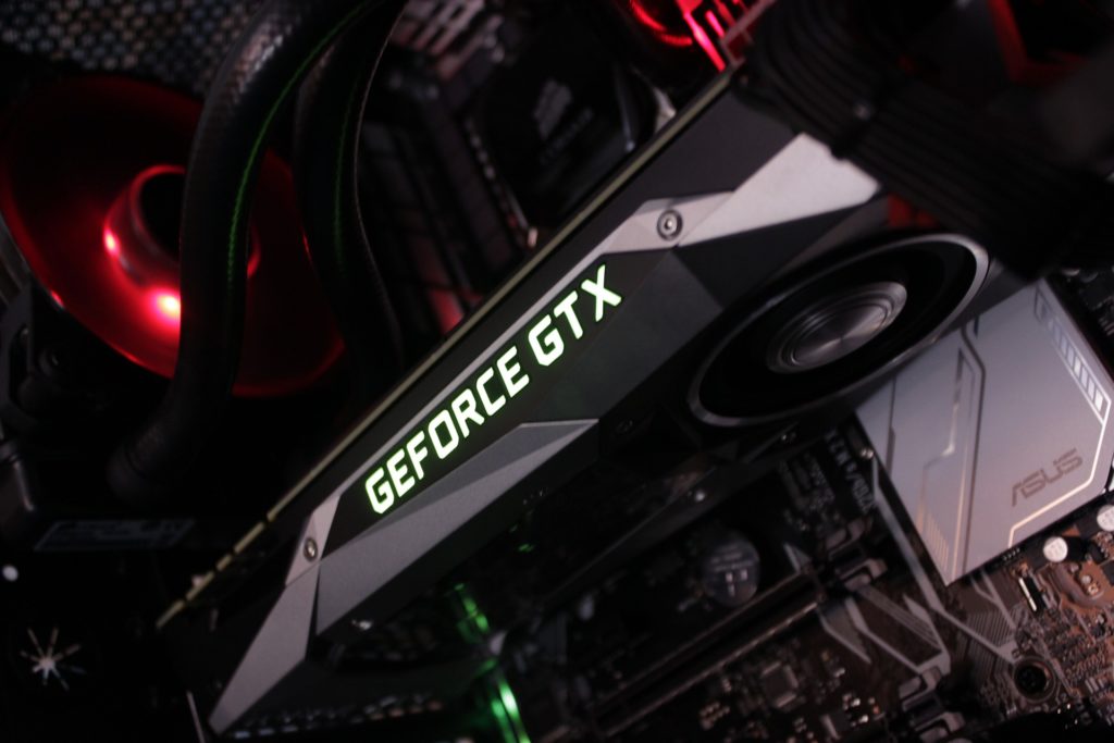 powerful geforce gtx graphics card in stylish custom pc setup with rgb lighting.