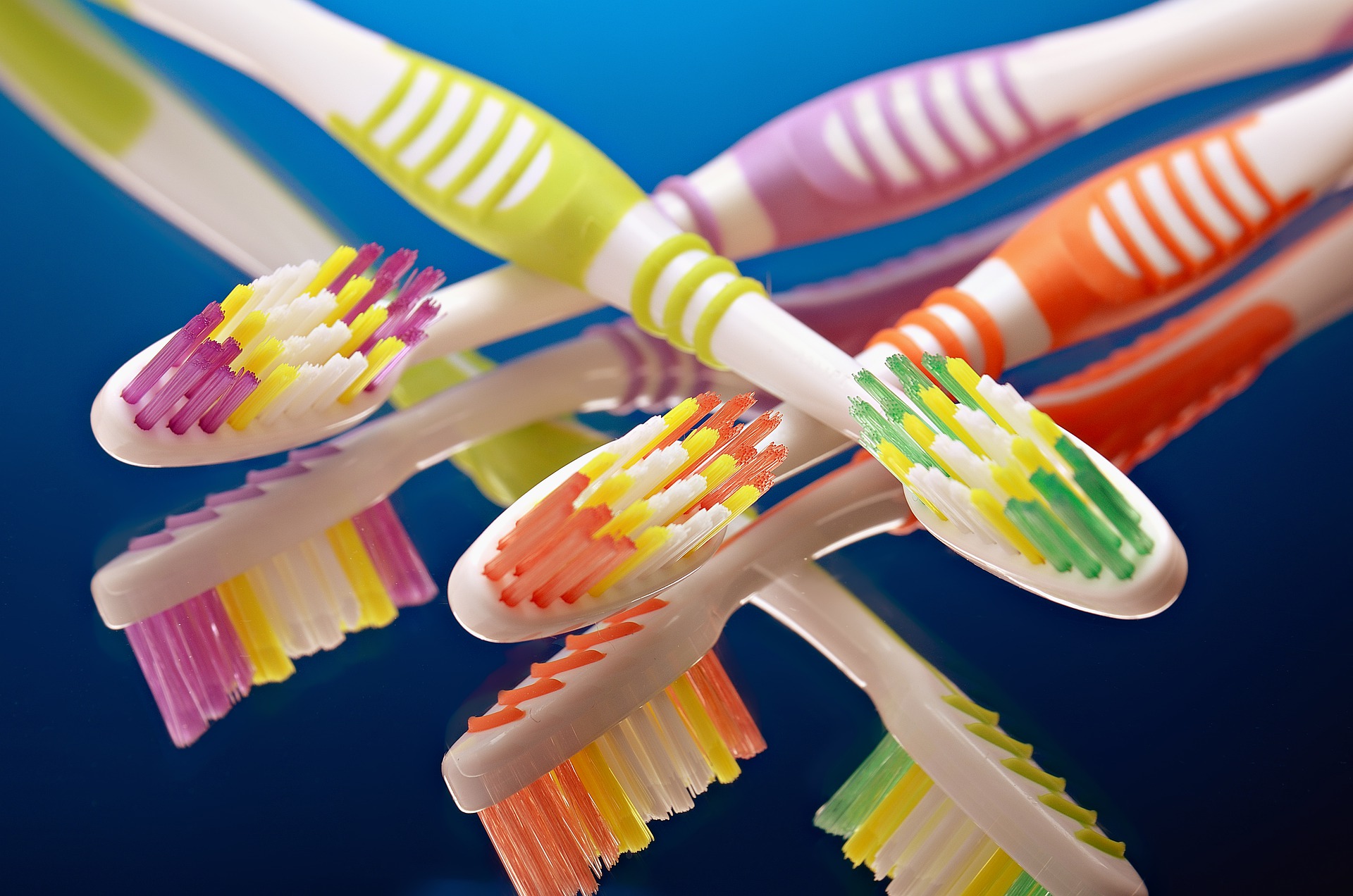 a group of multicolored toothbrushes sitting next to each other