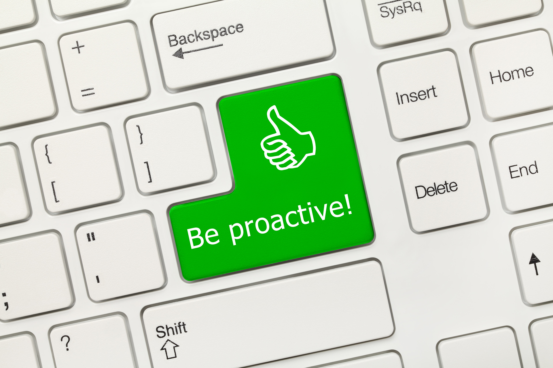 a keyboard with a green sticker that says be proactive