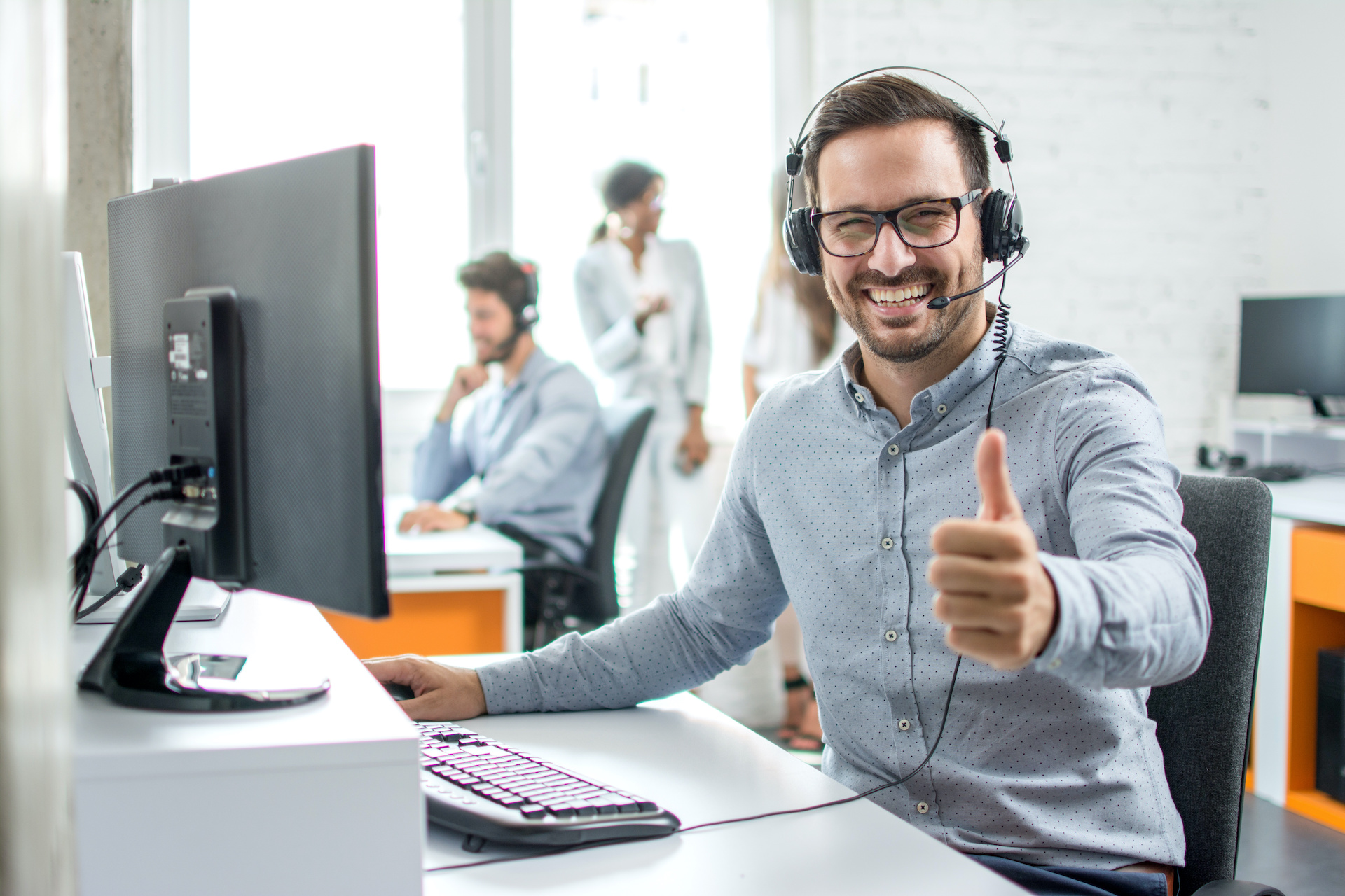a man wearing headphones giving a thumbs up