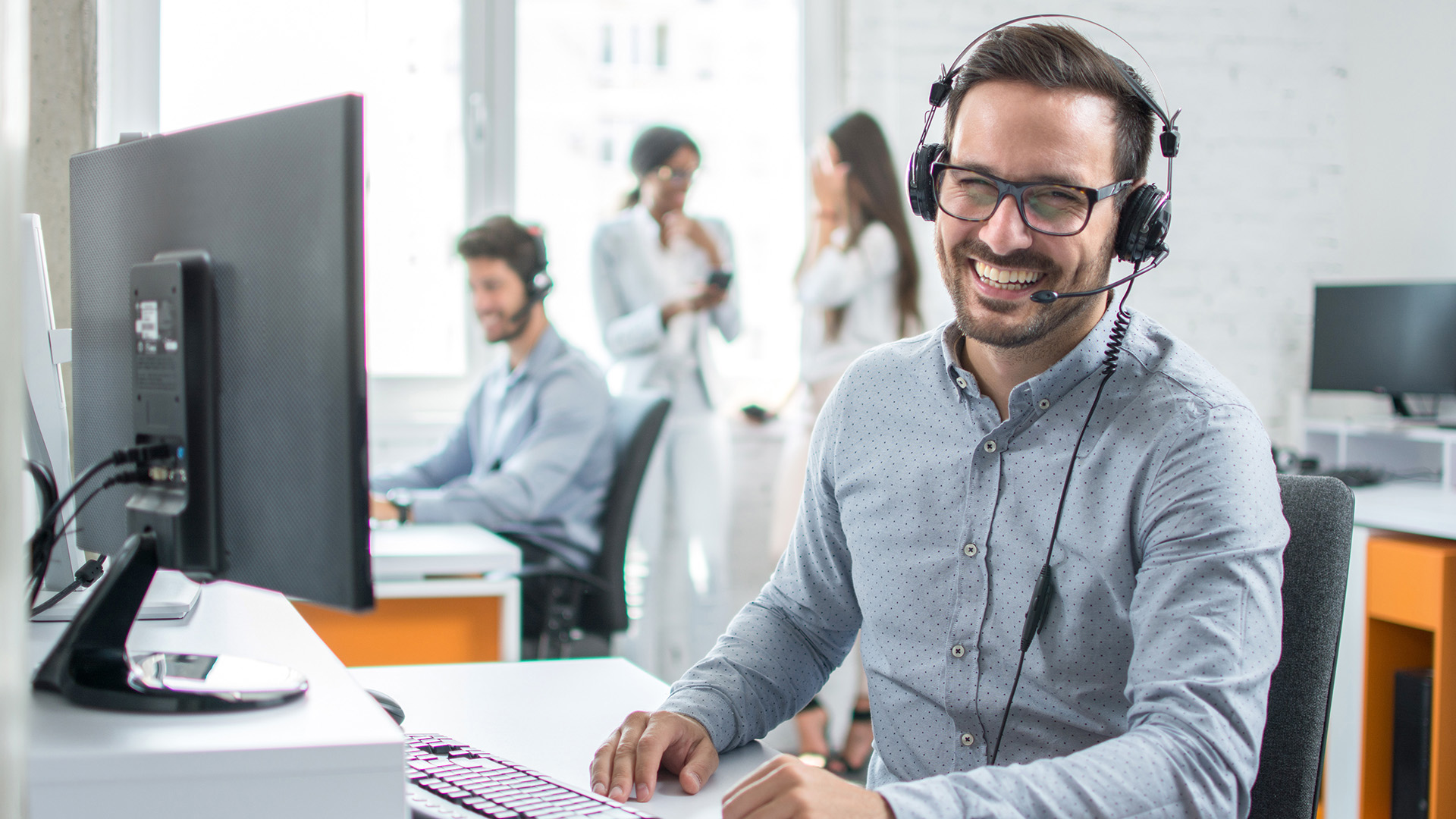 a man wearing headphones and using a computer