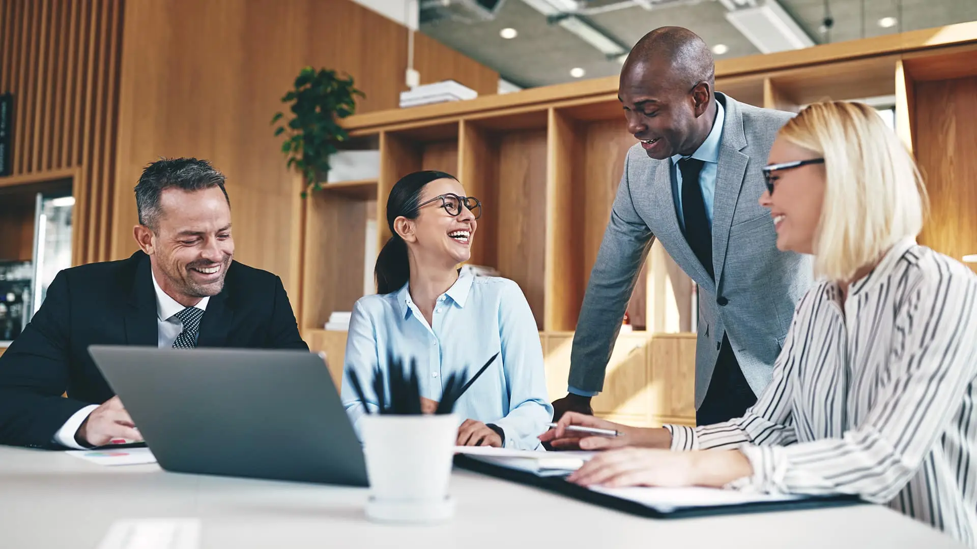 a group of business people sitting around a table