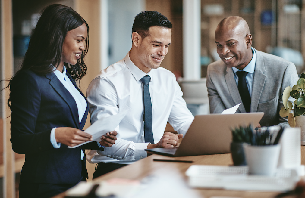 three business people looking at a laptop screen