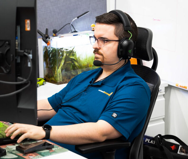 a man sitting at a desk wearing headphones