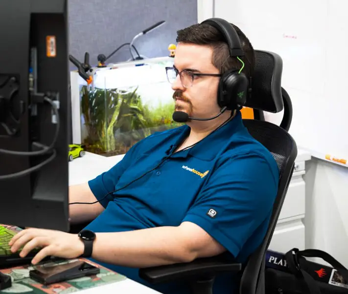 a man sitting at a desk wearing headphones