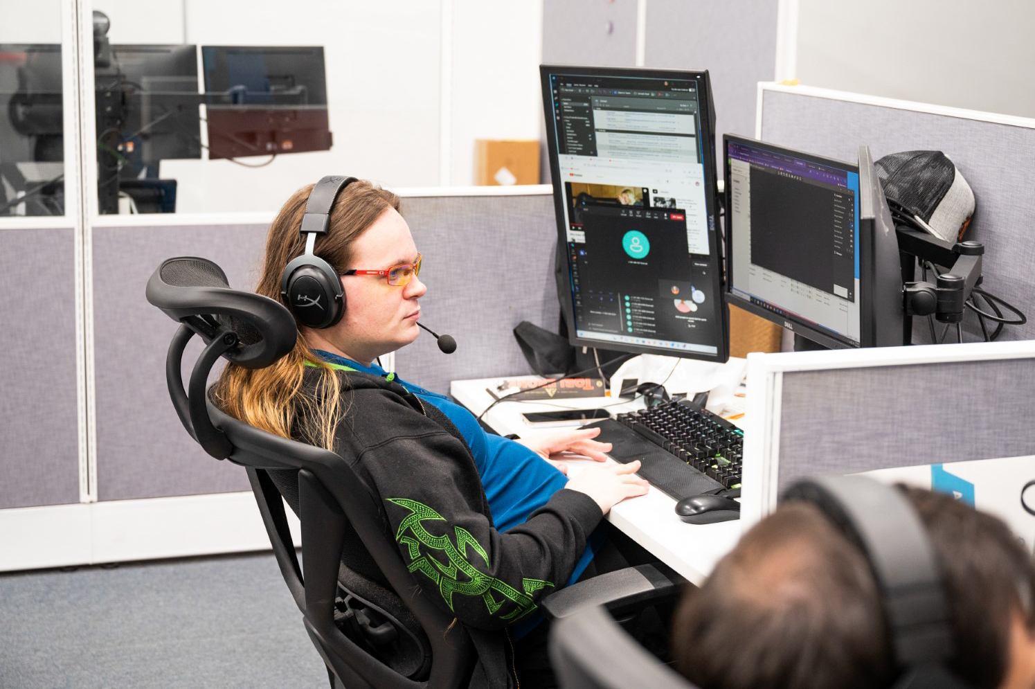 a woman sitting at a desk with headphones on