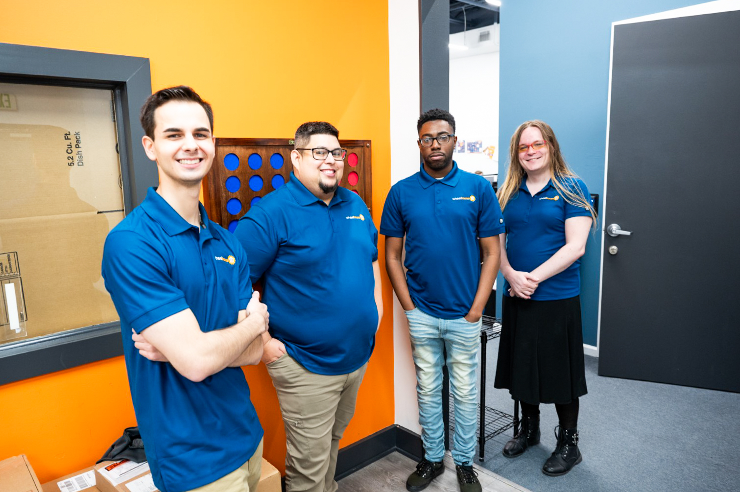 a group of people in blue shirts standing next to each other