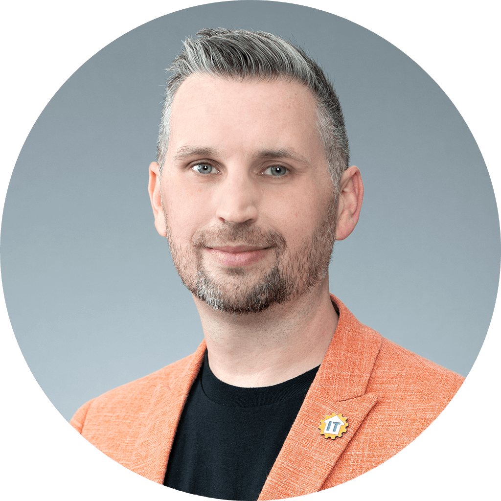 stylish man in orange blazer with friendly smile.